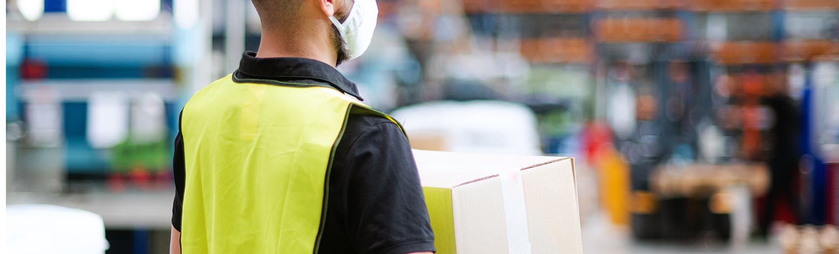 Man carrying package in warehouse