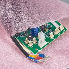Small circuit board inside anti-static pink Polyethelyne foam pouch.