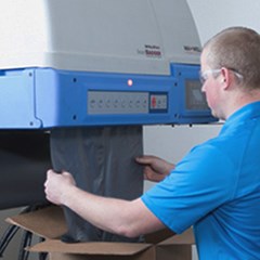 IntelliPack® SmartBagger™ machine is being used by a technician.