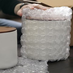 A fragile jar is wrapped with air cushions.