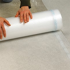 A person unrolls protective packaging film.