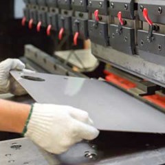worker processing metal sheet