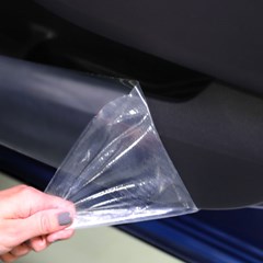Peeling off scratch resistant surface protection on car dashboard